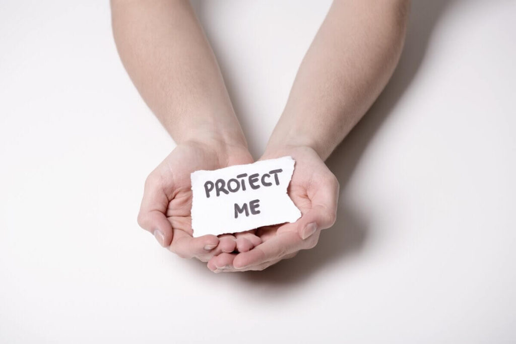 protect me written on a piece of paper and held in someone's cupped hands